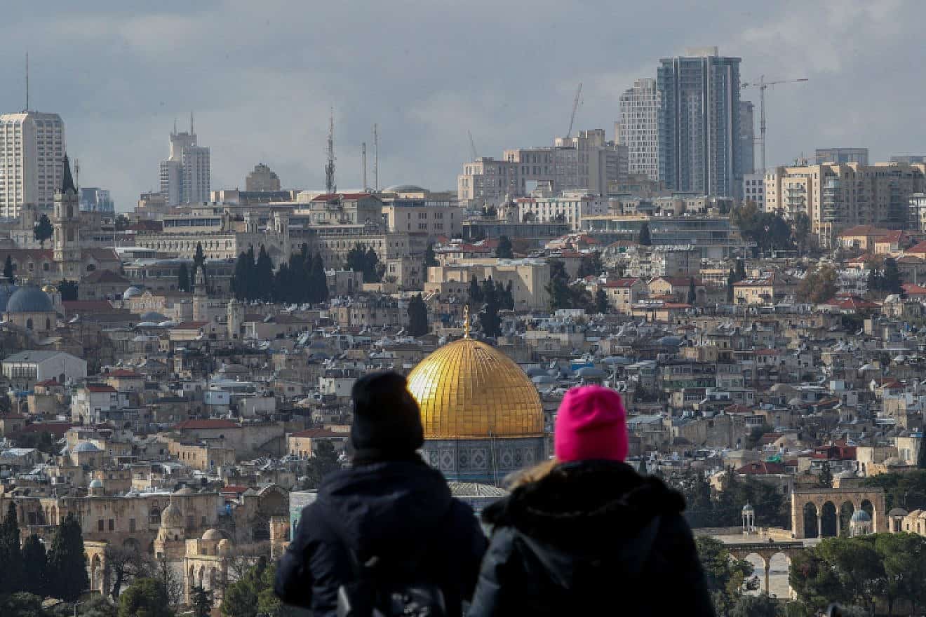 Tourists at a lookout point on the Mount of Olives gaze down on the Temple Mount and the Old City of Jerusalem, Feb. 8, 2023. Photo by Jamal Awad/Flash90.