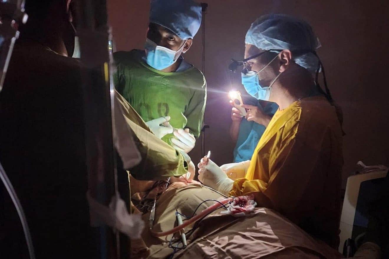 Israeli and Ethiopian doctors operating on a three-year-old child during a power failure at the St. Peter’s Hospital in Addis Ababa, Ethiopia. Photo by Dr. Vasile Recea via TPS.