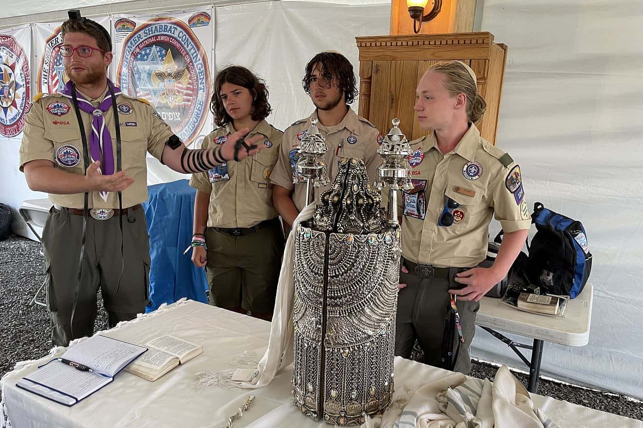 Rabbi Avi Hoffman (left) introduces the three Jewish Scout—from left: Gabriel and Joshua Greengas, and Coulton Perrmann—who each became a bar mitzvah at the 2023 National Scout Jamboree in Glen Jean, W.V., on July 24, 2023. Photo by the National Boy Scouts of America (BSA).