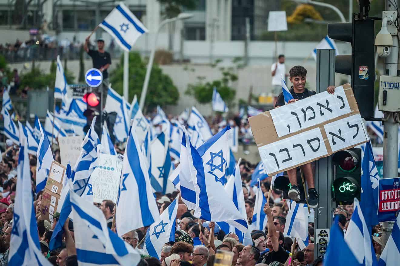 "Faithful and not a [reserve service] refuser," the sign reads at a rally in Tel Aviv in support of the government's judicial reform program, July 23, 2023. Photo by Avshalom Sassoni/Flash90.