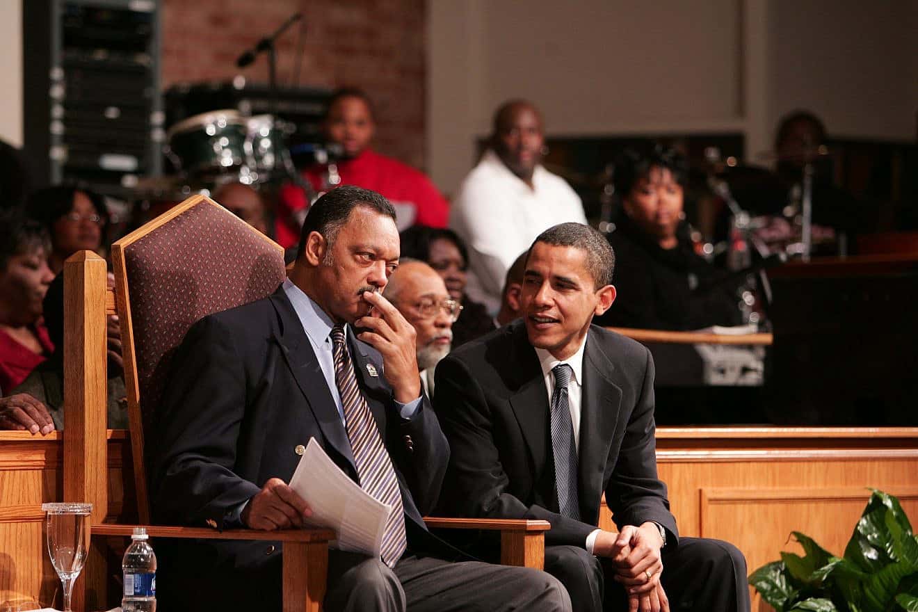 Then-Senator Barack Obama consults with Rev. Jesse Jackson Sr. Photo by S. White/Shutterstock.