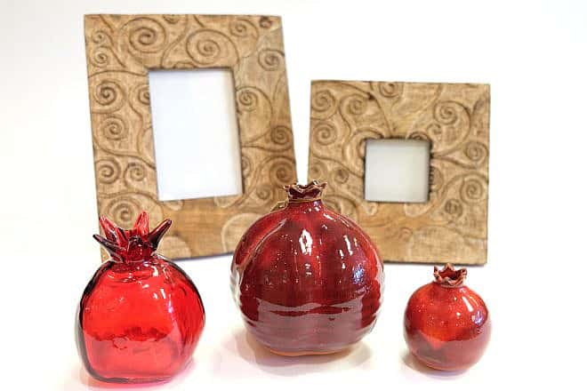 Glass pomegranates and hand-carved frames made in India. Credit: Dayenu.