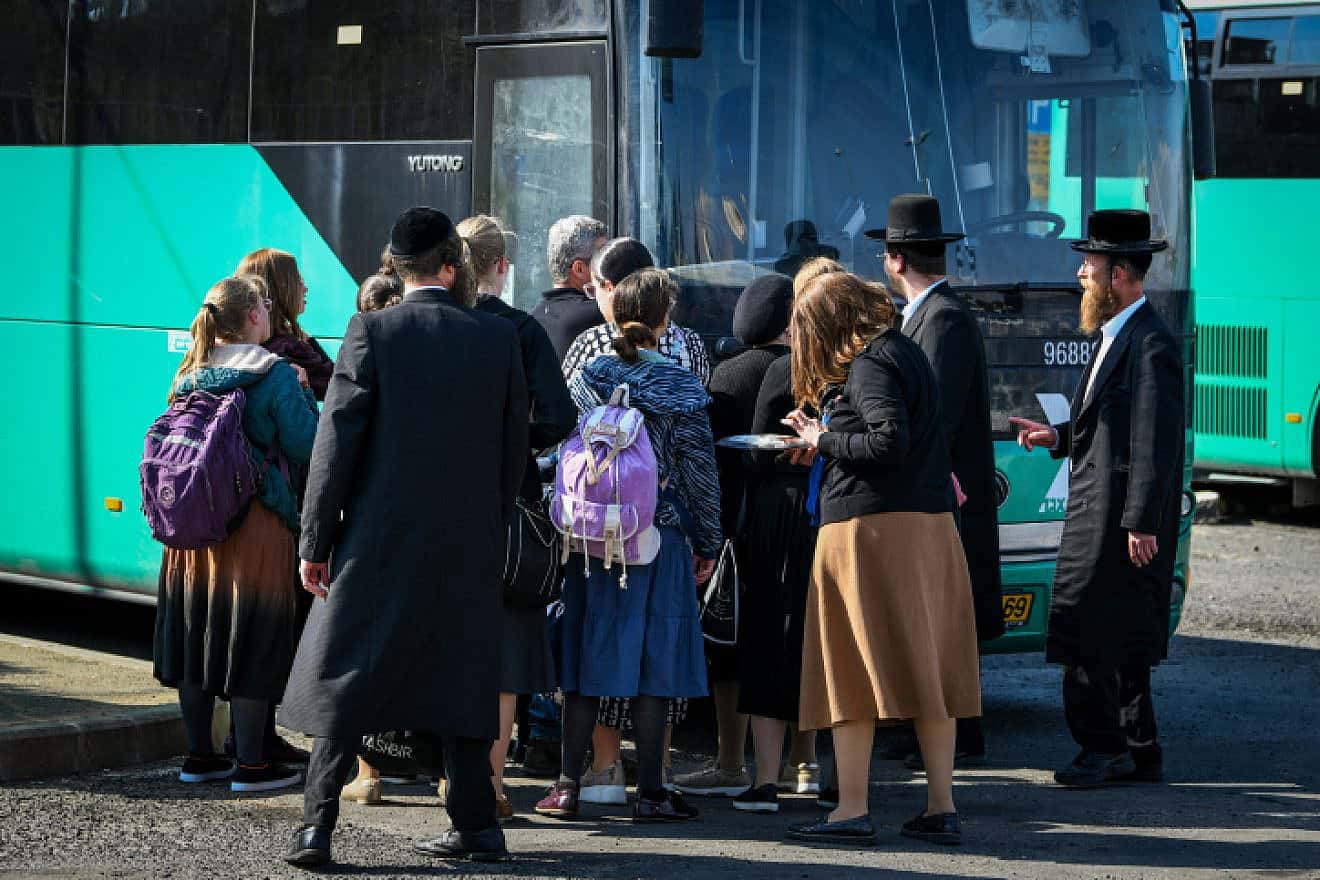Ultra-Orthodox Jews board the bus to the Lag B'Omer festivities at Mount Meron in the Upper Galilee, May 8, 2023. Photo by Arie Leib Abrams/Flash90.