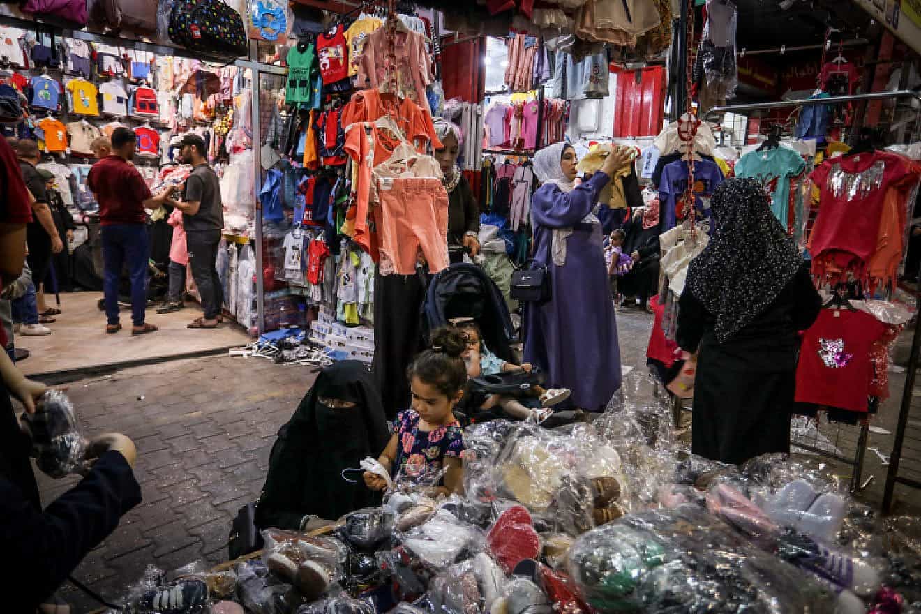 Palestinians shop at a market ahead of the Eid al-Adha festival, in Rafah, in the southern Gaza Strip, on June 27, 2023. Photo by Abed Rahim Khatib/Flash90.