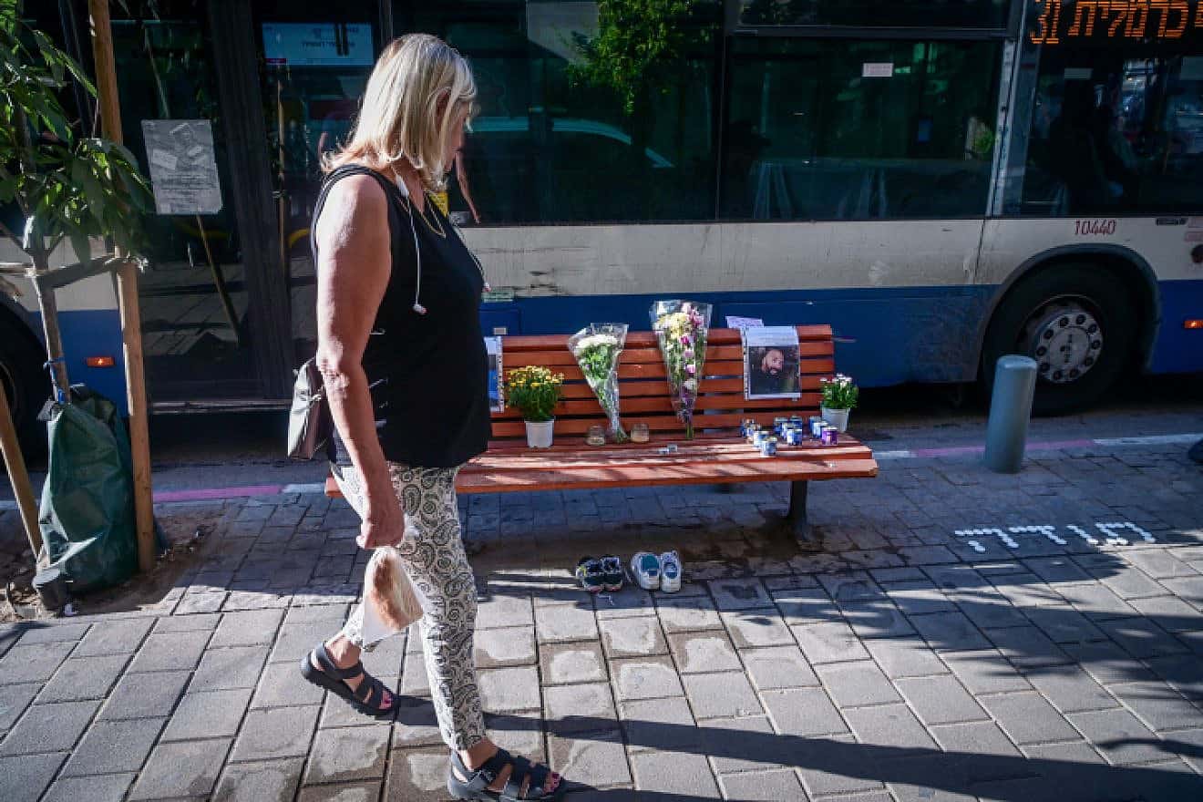 Candles and pictures of Chen Amir, a municipal patrolman killed by a terrorist, at the scene of the attack in Tel Aviv, Aug. 6, 2023. Photo by Avshalom Sassoni/Flash90.