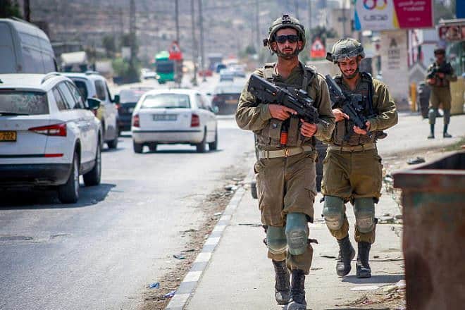 Israeli soldiers patrol at the scene of a deadly terror attack in Huwara, near Nablus in Judea and Samaria, Aug. 20, 2023. Photo by Nasser Ishtayeh/Flash90.