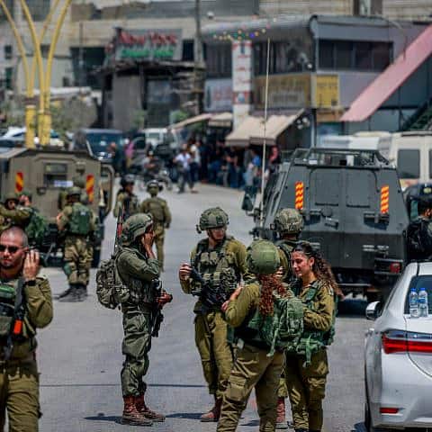 Israeli security forces at the entrance to Hebron following deadly shooting attack on Route 60, Aug. 21, 2023. Photo by Chaim Goldberg/Flash90.