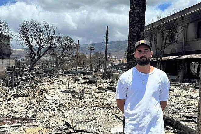 Ido Sarfati stands outside the remains of his businesses that were destroyed by wildfires last week that swept through Lahaina on the island of Maui, Aug. 14, 2023. Photo courtesy of Ido Sarfati.