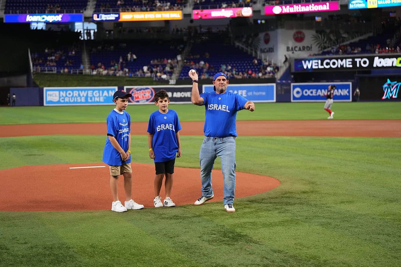 Maor Elbaz-Starinsky, Israeli consul general in Miami, throws out the first pitch with two of his children, Noam (left) and Itai, before the Miami Marlins home game against the Washington Nationals for the Jewish Community Celebration on Aug. 27, 2023. Credit: Courtesy of the Miami Marlins.