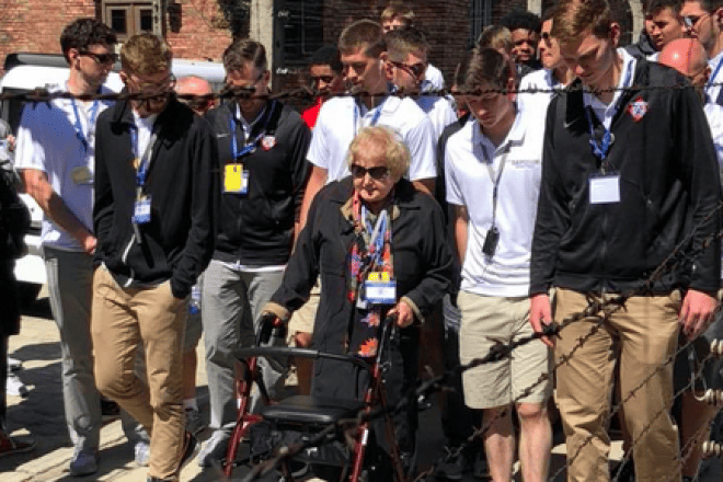 The Davidson College basketball team and Eva Mozes Kor reenacting her liberation walk in Auschwitz