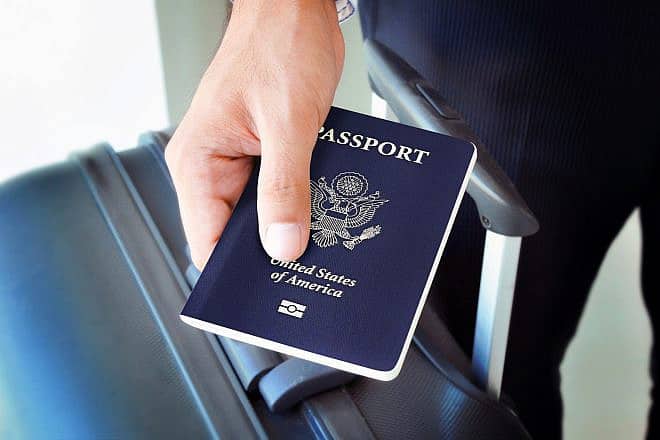 A traveler holds a U.S. passport. Credit: Atstock Productions/Shutterstock.