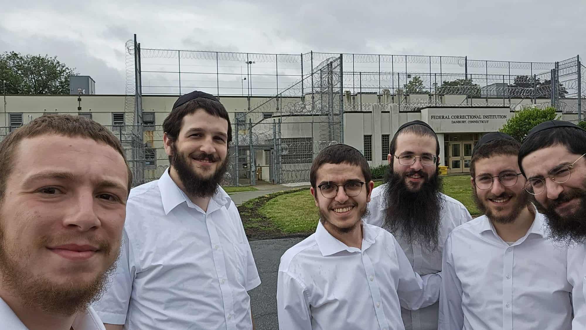 Rabbi Yisroel Baumgarten (left), a volunteer for the Aleph Institute who visits prisons ahead of the the High Holidays, with other volunteers gathered for a training course at the Federal Correctional Institution in Danbury, Conn. Credit: Courtesy of Rabbi Yisroel Baumgarten.