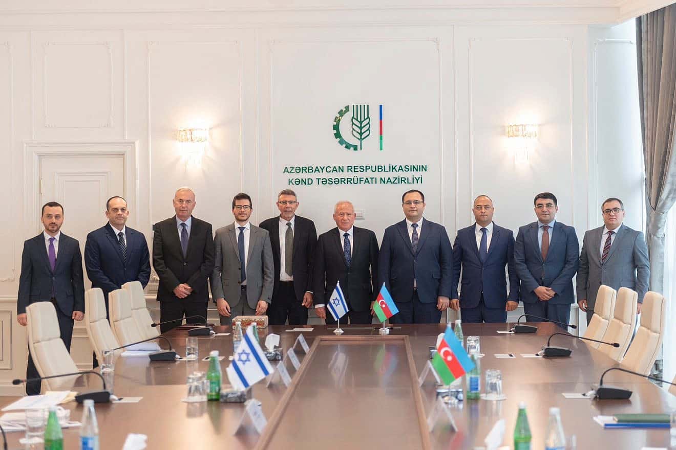 Israeli Agriculture Minister Avi Dichter (center, behind the Israeli flag) at the signing of a declaration of intent regarding wheat production with Azerbaijan, Sept. 11, 2023. Credit Israeli Ministry of Agriculture.