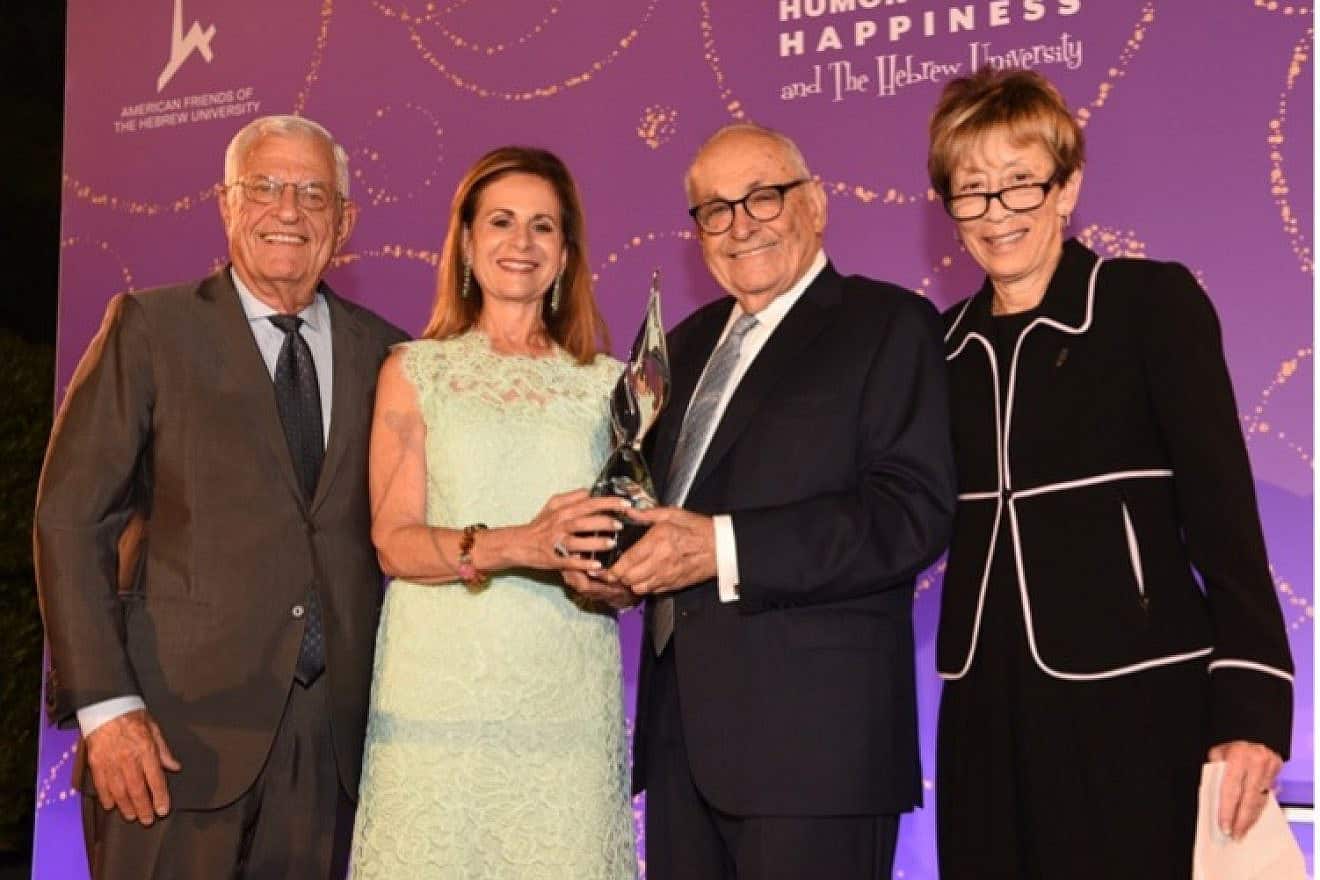 Roberta and Stanley Bogen (center) holding the AFHU Humanitarian Torch of Learning Award presented during the 14th Annual Bel Air Affaire at the iconic Papillon Estate in Beverly Hills. Honorary event chairs pictured here are Richard Ziman (far left) and Patricia L. Glaser (far right). Credit: Robert Lurie Photography.