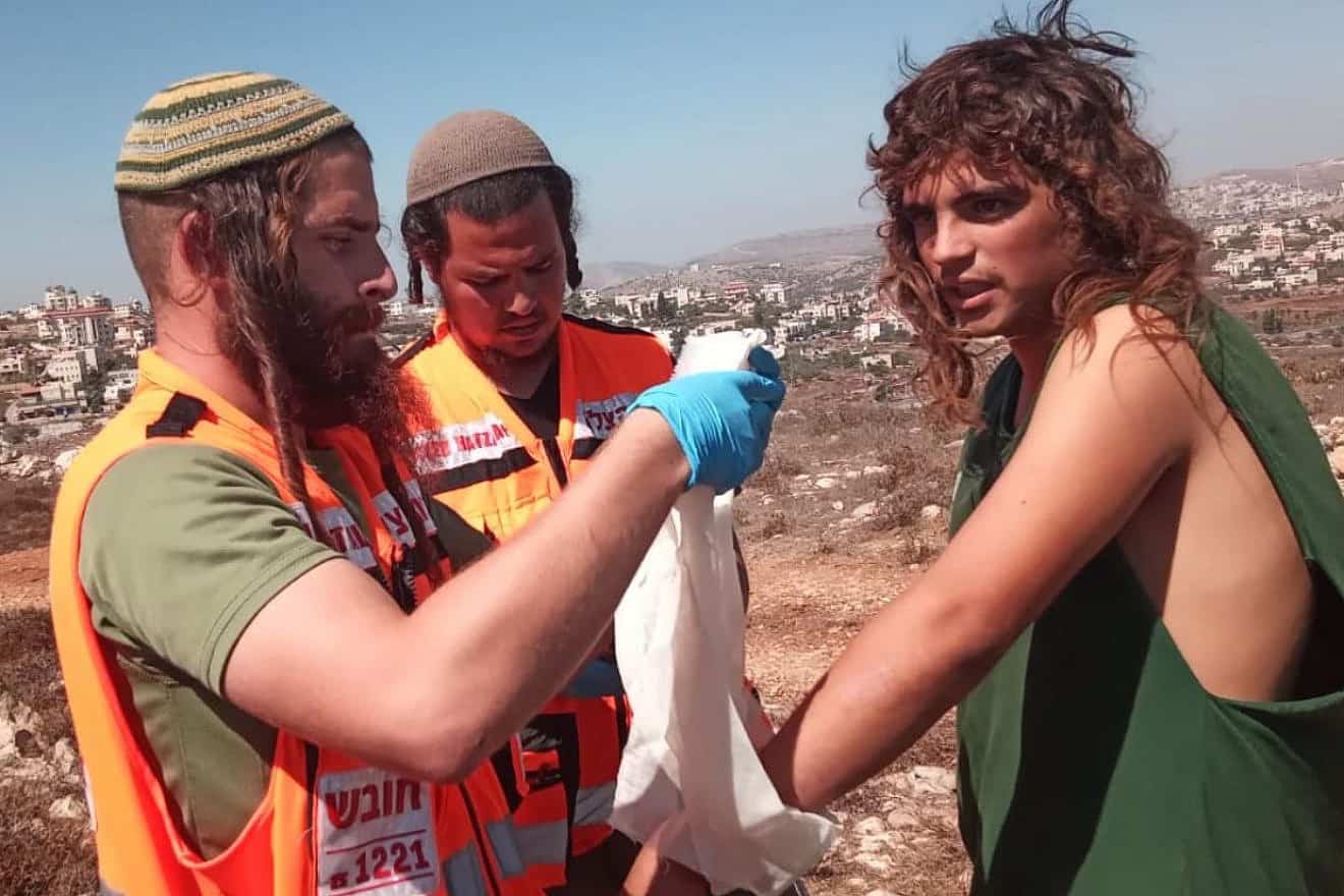 Medics dress the broken hand of a youth who claims police beat him during the evacuation of Givat Or Meir in the Binyamin region of Samaria, Sept. 27, 2023. Source: X.
