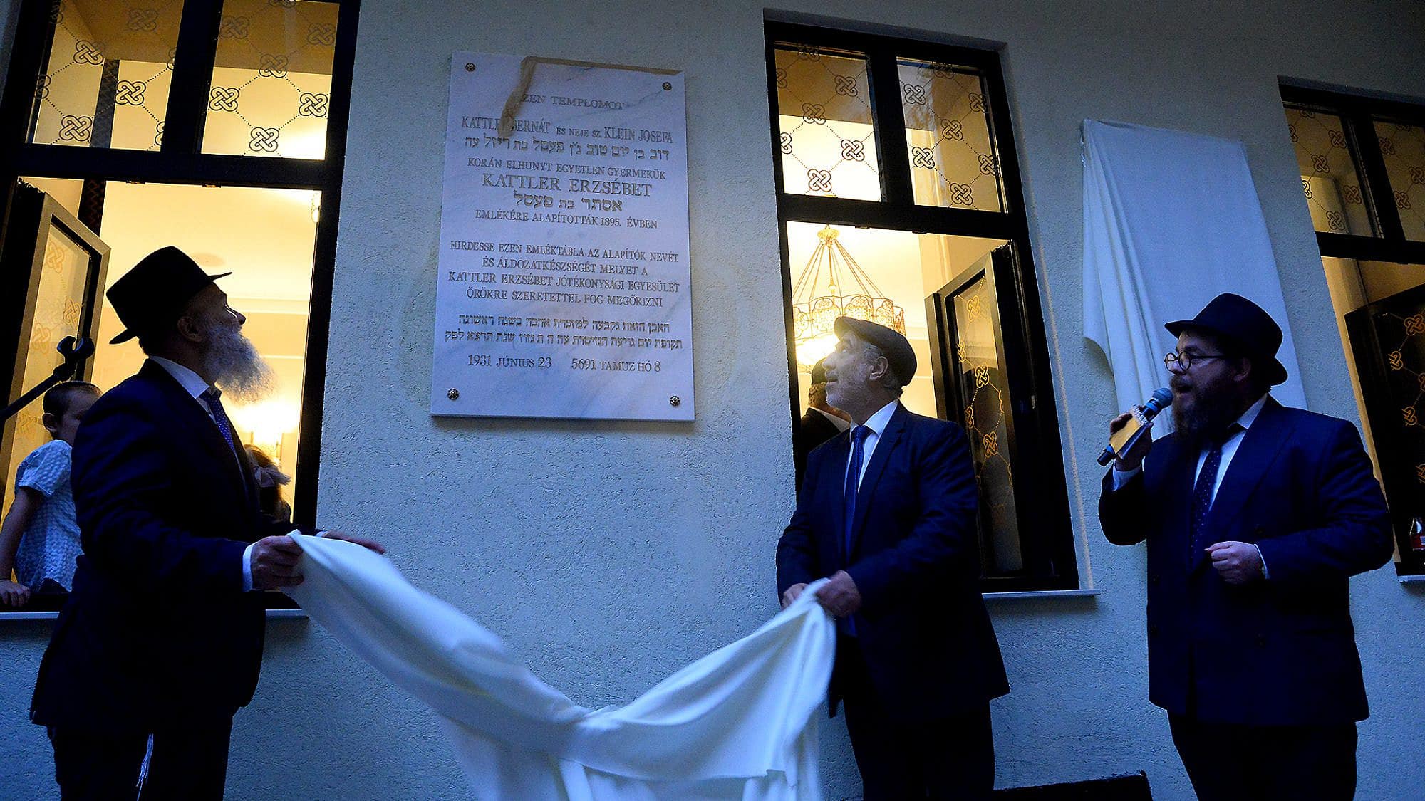 Community members unveil a plaque at the reopening of the Ohel Ezster synagogue in Budapest, Sept. 5, 2023. Photo by Zsolt Demecs.