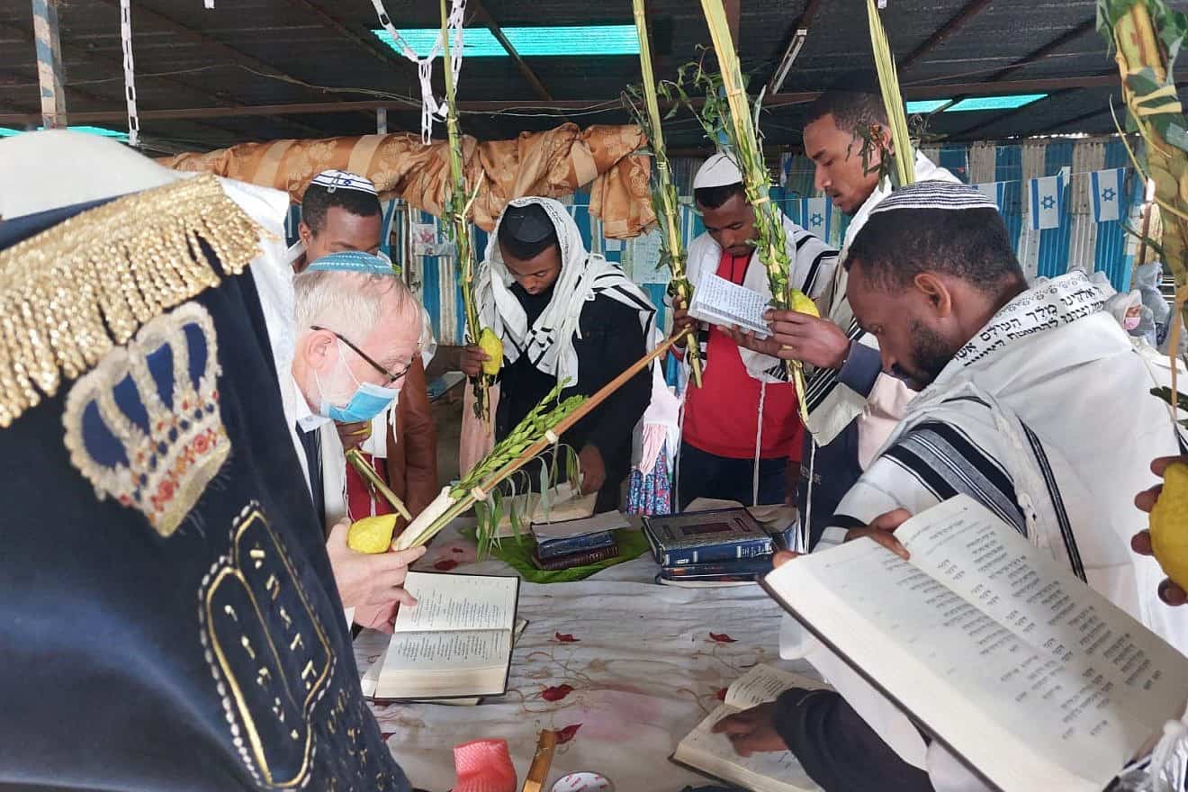 Ethiopian Jews pray in the sukkah during the Jewish holiday of Sukkot. Credit: Courtesy of Struggle to Save Ethiopian Jews.