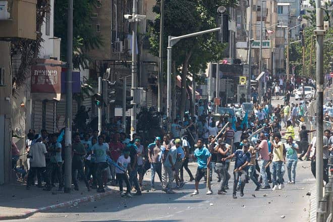 Eritrean asylum-seekers who oppose the regime in Eritrea and pro-regime activists clash with police in south Tel Aviv, Sept. 2, 2023. Photo by Omer Fichman/Flash90.