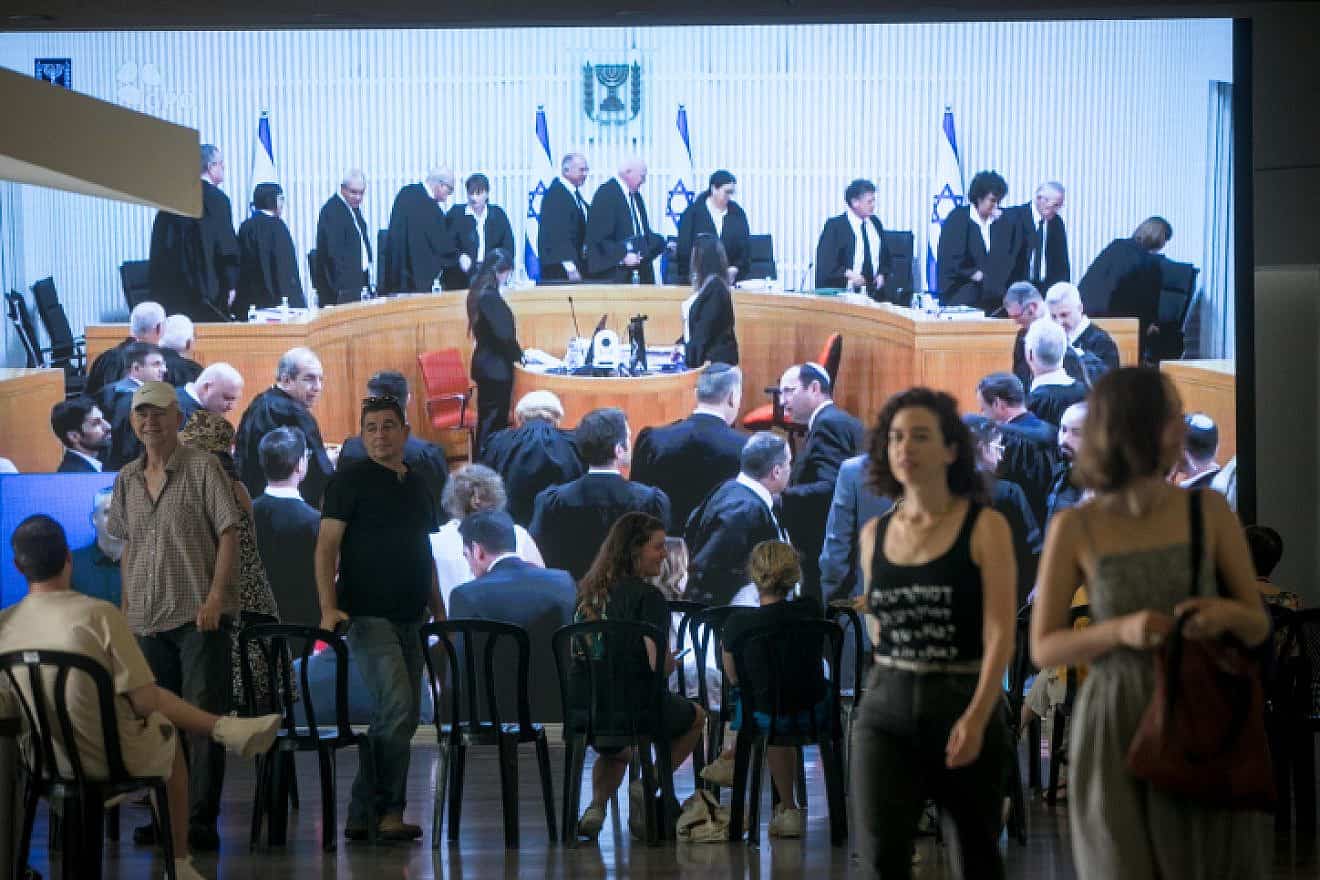 Israelis watch a live screening of a court hearing on petitions against the government's amendment to Basic Law: The Judiciary, at the Tel Aviv Museum of Art, Sept. 12, 2023. Photo by Miriam Alster/Flash90.