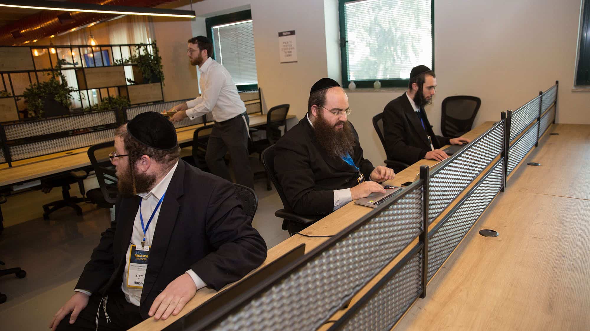 Ultra-Orthodox men work at the Bizmax Innovative Business Complex in Jerusalem, which endeavors to integrate Haredi men into various careers, Feb. 23, 2017. Credit: Flash90.