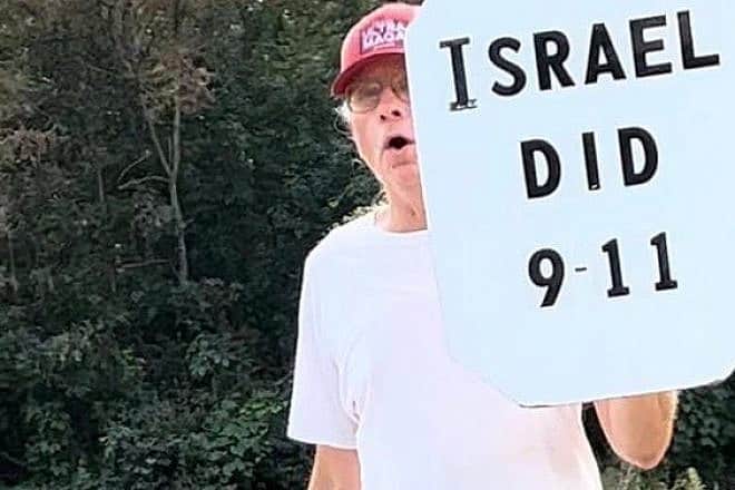 An older man holds a sign that reads: “Israel Did 9-11” across from a school in Poughkeepsie, N.Y., on Sept. 6, 2023. Source: StopAntisemitism/Twitter.