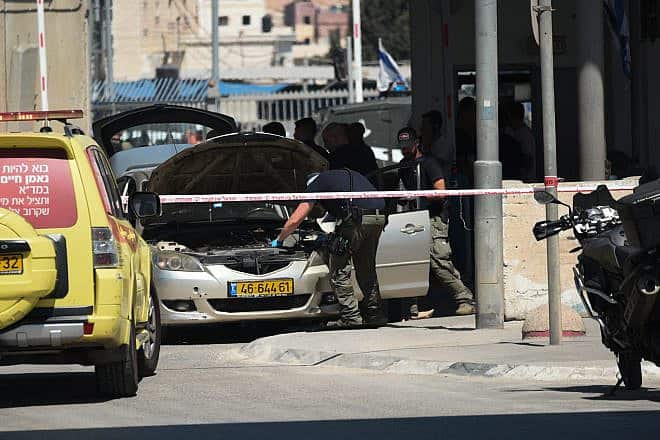 Police examine the terrorist's car at the Qalandia crossing, south of Ramallah, Sept. 21, 2023. Photo by Yoav Dudkevitch/TPS.