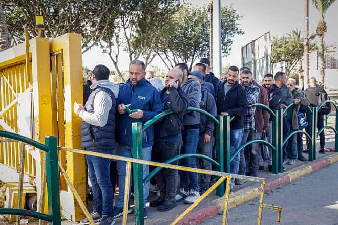 Palestinian workers line up at the entrance to Ma'ale Adumim near Jerusalem, Feb. 23, 2023. Photo by Erik Marmor/Flash90.