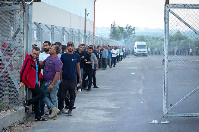 Palestinian workers from the Gaza Strip stand in line to enter through the Erez border crossing to Israel on Sept. 28, 2023. Photo by Atia Mohammed/Flash90.