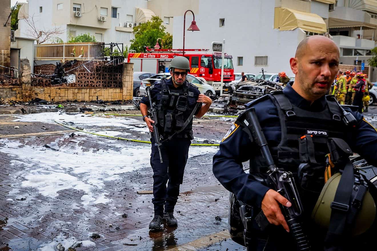 Israeli security and rescue forces at the scene where a rocket fired from the Gaza Strip hit buildings and cars in the southern Israeli city of Ashdod, Oct. 9, 2023. Credit: Liron Moldovan/Flash90.