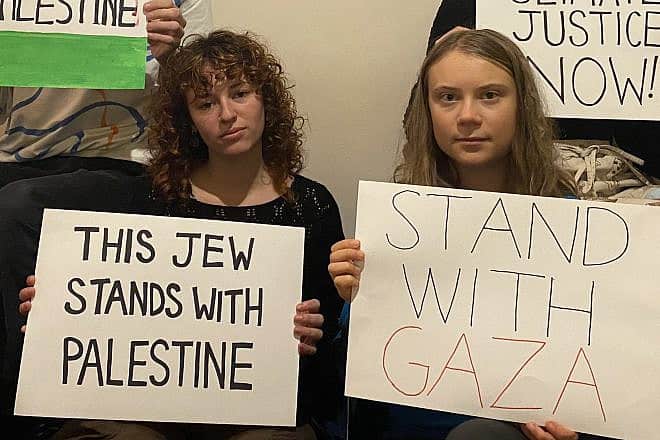 Swedish activist Greta Thunberg (right) holds a sign in support of Gaza that she shared to her social media followers. Source: Twitter.