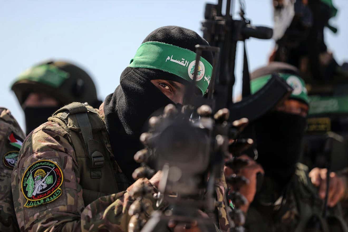 Hamas terrorists march along the border fence between Israel and the Gaza Strip, July 19, 2023. Photo by Majdi Fathi/TPS.