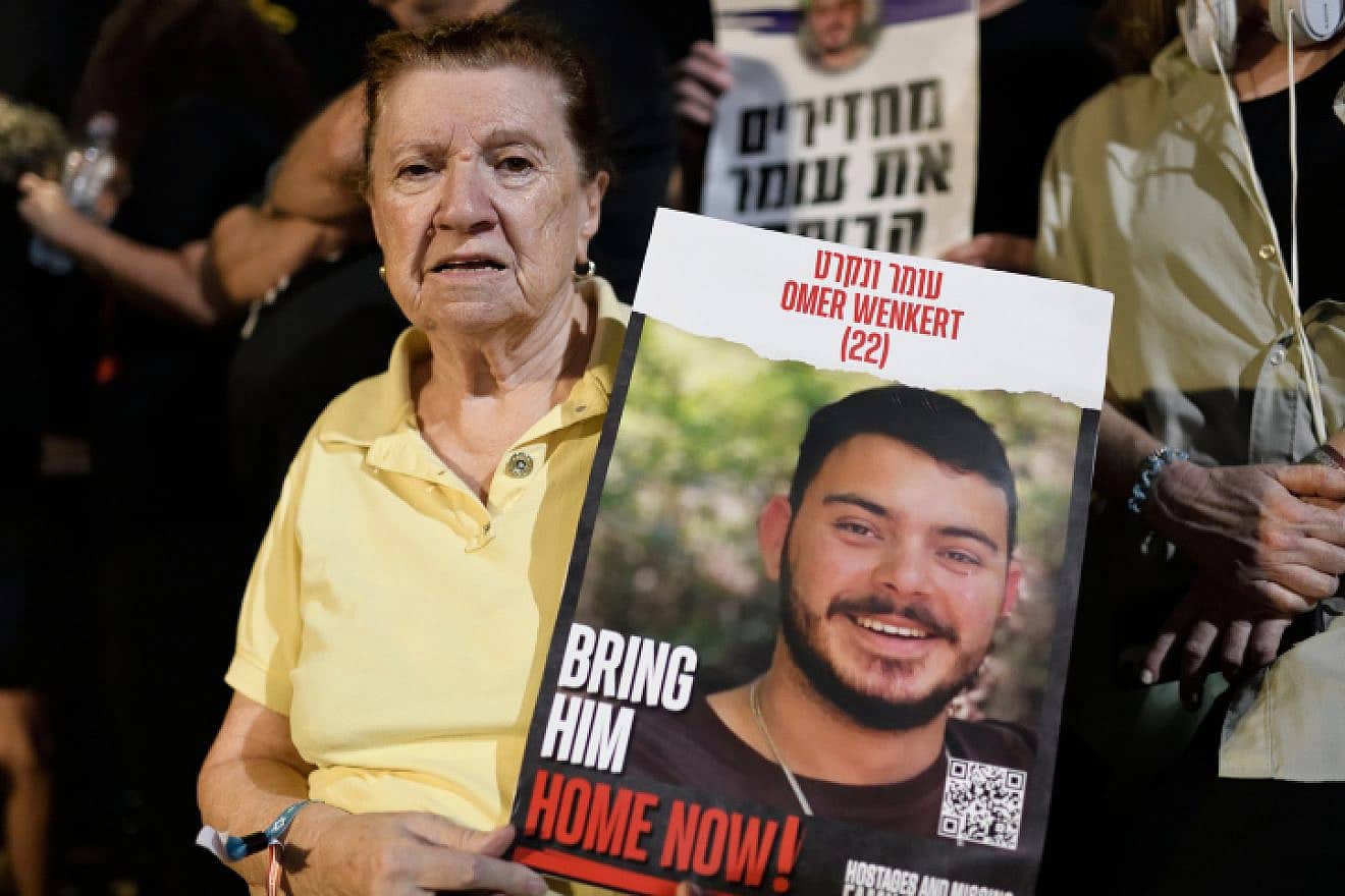 Holocaust survivor Tzili Wenkert holds a placard depicting her grandson Omer Wenkert, whom Hamas holds captive in Gaza, at an event at "Hostages Square" outside the Tel Aviv Museum of Art, Oct. 28, 2023. Photo by Gili Yaari /Flash90.