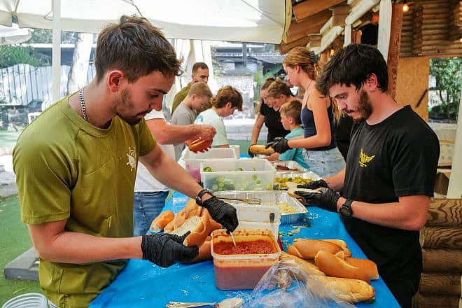 Israeli volunteers of all ages collect, cook and deliver BBQ sandwiches free of charge for the thousands of reserve soldiers stationed in the Golan Heights, Oct. 10, 2023. Photo by Michael Giladi/Flash90.