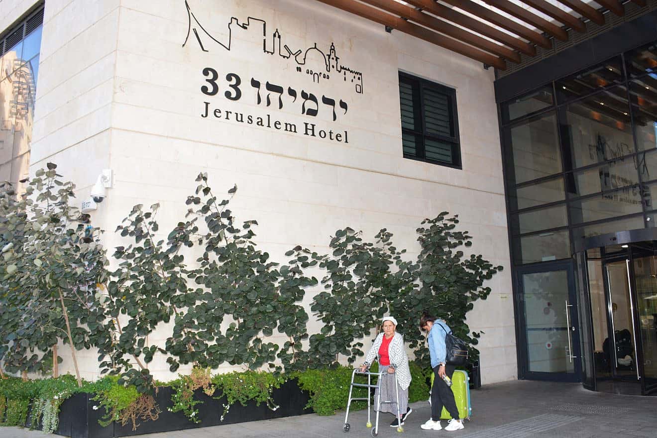 A guest displaced from the war with Hamas in the Gaza Strip walks outside Yad Sarah's “Yirmiyahu 33” Rehabilitation and Wellness Hotel in Jerusalem, October 2023. Credit: Courtesy.