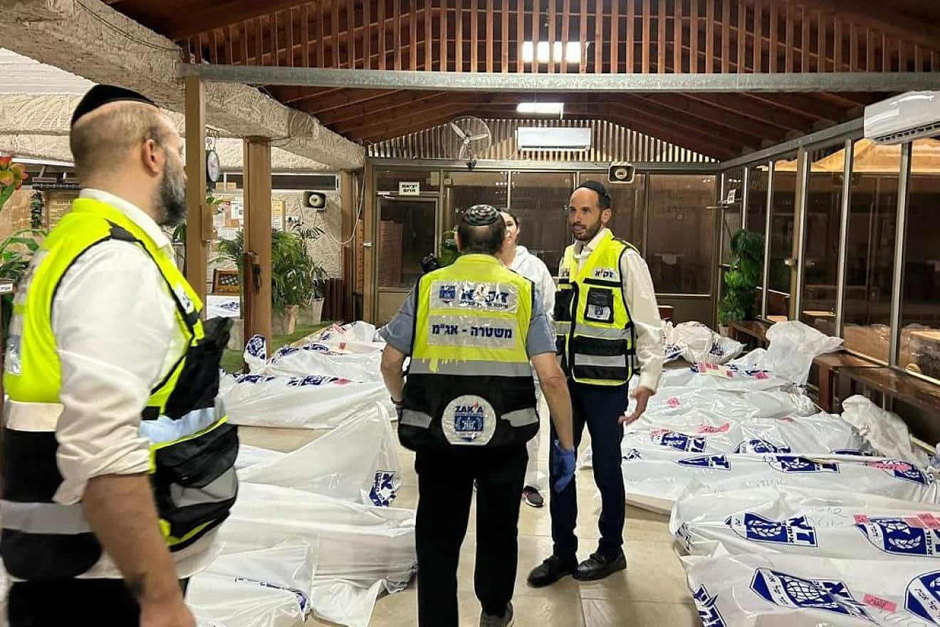 ZAKA volunteers at Kibbutz Be'eri identifying the bodies of Israelis slain by Hamas terrorists, Oct. 11, 2023. Credit: ZAKA.