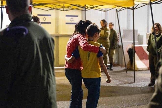 Freed Israeli hostage Eitan Yahalomi, 12, meets his mother upon his return to Israel at the Kerem Shalom Crossing on Nov. 27, 2023. Credit: IDF Spokesperson.