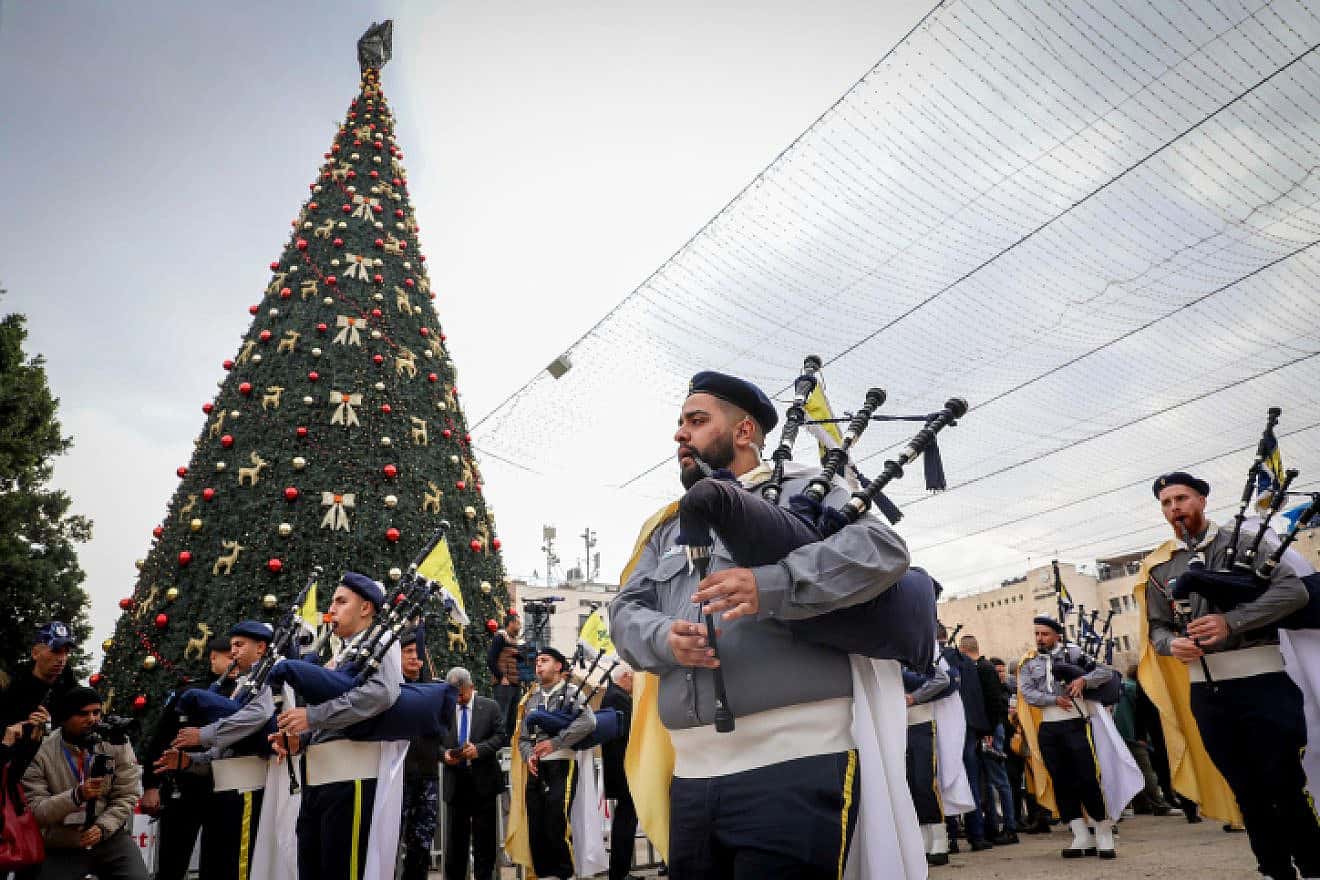 Palestinians march during a Christmas parade outside the Church of the Nativity on the eve of Christmas, Dec. 24, 2022. Photo by Wisam Hashlamoun/Flash90.
