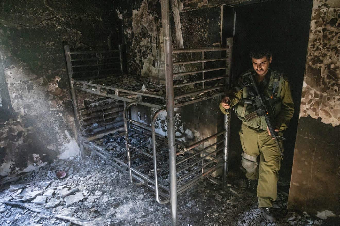 An Israeli soldier surveys the aftermath of Hamas's Oct. 7 massacre in Kibbutz Nir Oz, Oct. 30, 2023. Photo by Chaim Goldberg/Flash90.