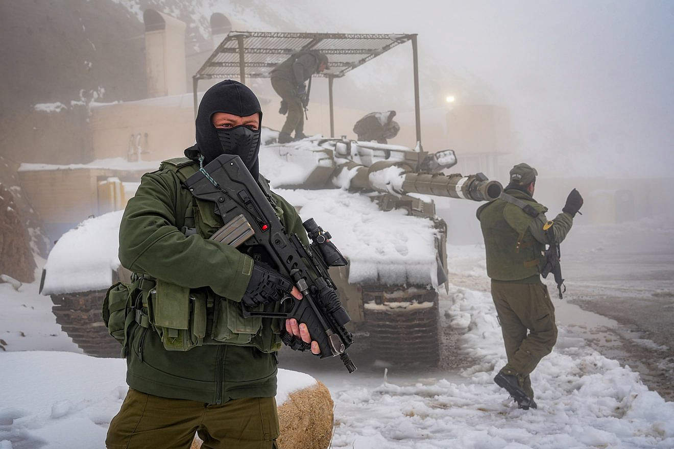 Israeli soldiers patrol in the snow in Mount Hermon, near the borders with Syria and Lebanon, Nov. 20, 2023. Photo by Ayal Margolin/Flash90.