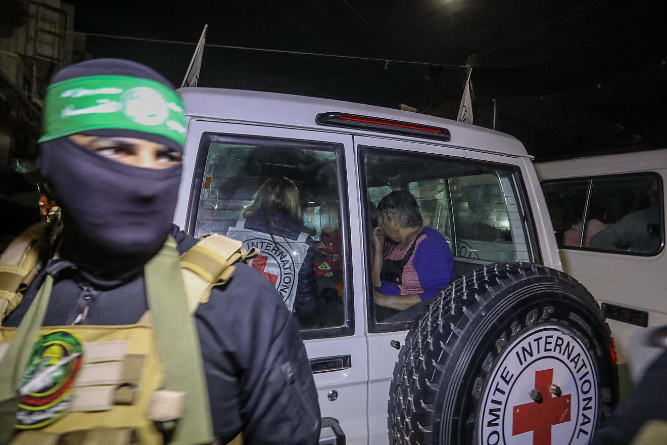 A Hamas terrorist releases Israeli hostages to the Red Cross, in Rafah, in the southern Gaza Strip, Nov. 28, 2023. Credit: Flash90.