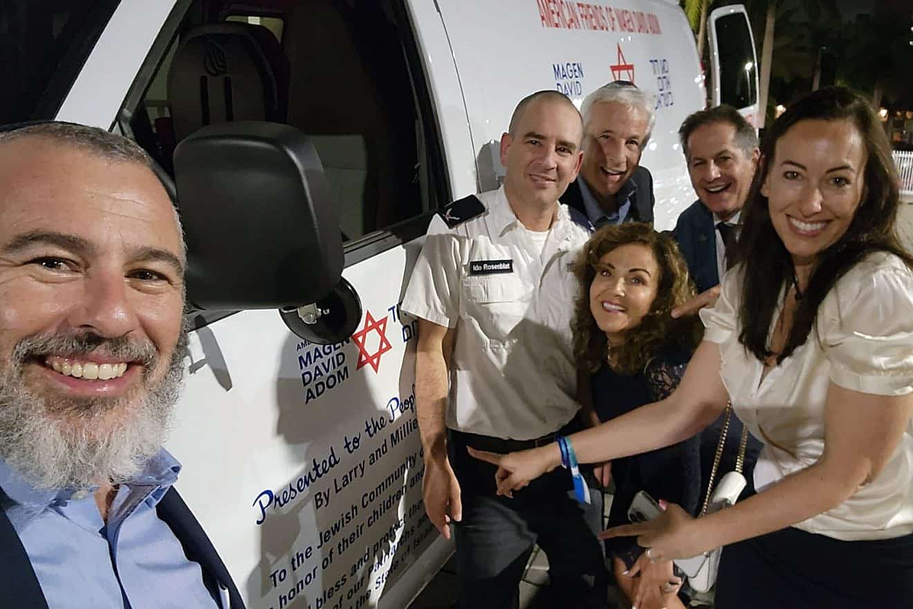 From left: Yishai Fleisher, international spokesman for the Jewish Community of Hebron; Ido Rosenblatt, chief information officer for Magen David Adom; donors Larry and Millie Magid; Paul Kruss, Aventura City Commissioner; and entrepreneur Marian Kruss at an event in Aventura, Fla., to donate an ambulance to Magen David Adon, Nov. 20, 2023. Credit: Courtesy of MDA.