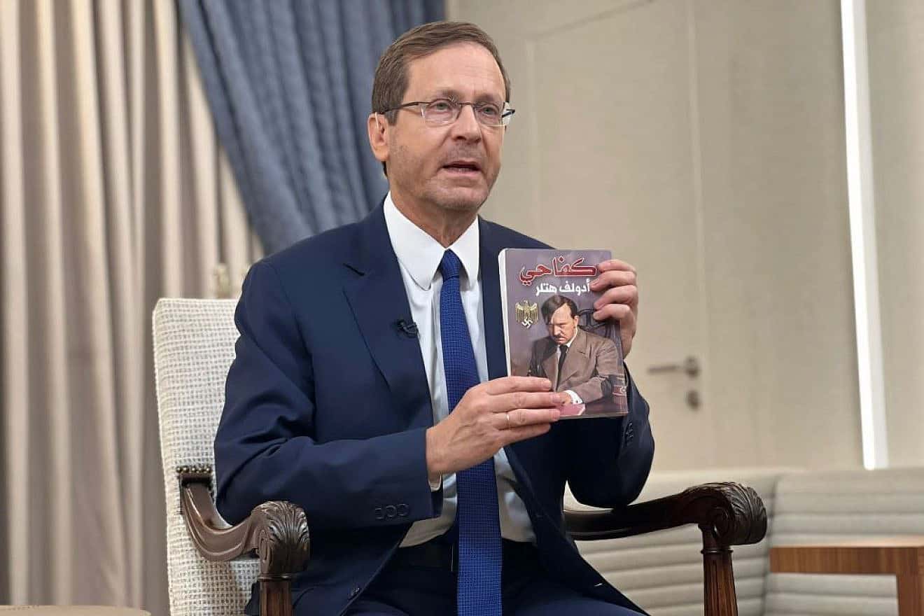 Israeli President Isaac Herzog holds up a copy of an Arabic translation of "Mein Kampf" that was found by IDF troops in a children's room used as a Hamas terror base in the Gaza Strip, Nov. 12, 2023. Credit: Israeli President's Residence.