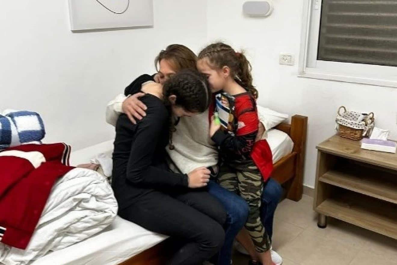 Ma’ayan Zin hugged her two daughters, Dafna Elyakim, 15, and Ela Elyakim, 8, after they were released by Hamas from Gaza on Nov. 26, 2023. Credit: Courtesy.