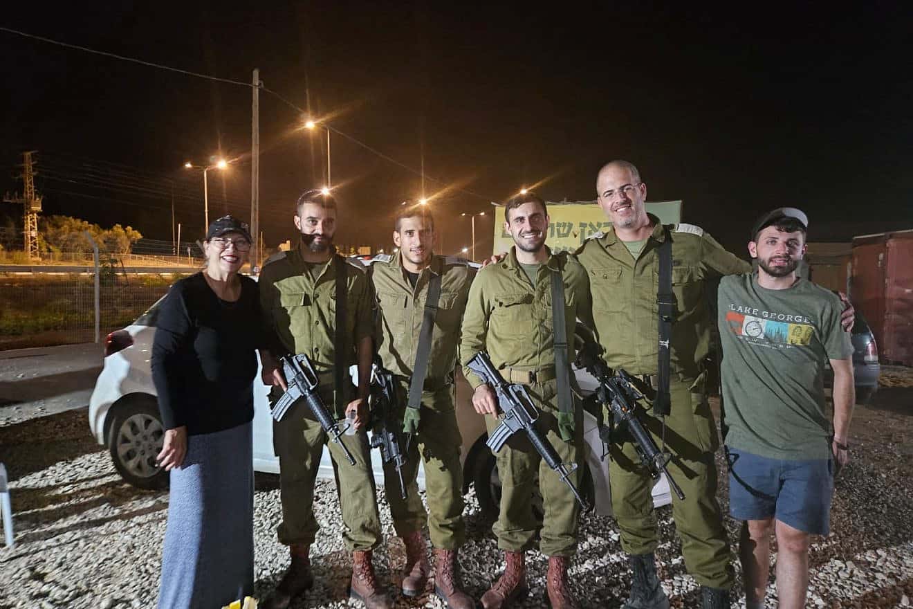American Israel Tolchinsky (right) and another volunteer with IDF soldiers. Photo: Courtesy.