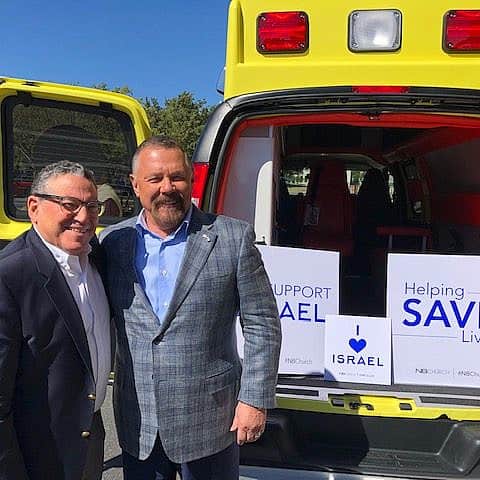 Richard Zelin (left) and Pastor Larry Huch next to a Mobile Intensive Care Unit ambulance sponsored by New Beginnings Church in 2019. Credit: Courtesy.
