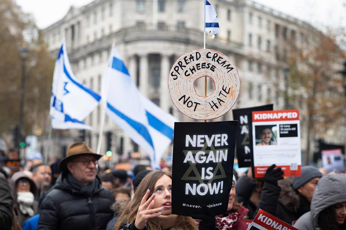 Pro-Israeli protesters at the “March Against Antisemitism” in London hold flags and placards in support of hostages taken by Hamas in Gaza, Nov. 26, 2023. Credit: Andy Soloman/Shutterstock.