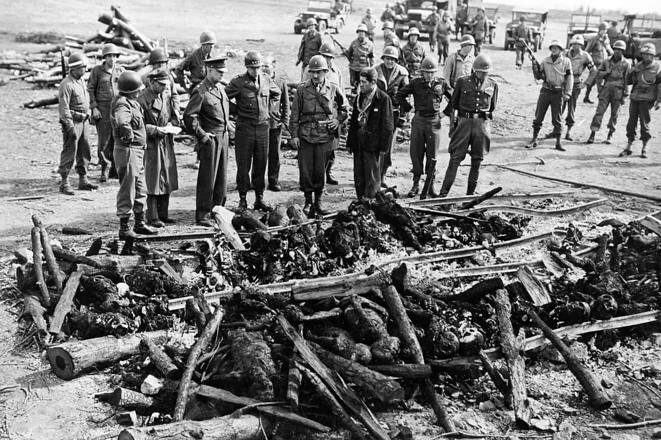 On an inspection tour of the newly liberated Ohrdruf concentration camp, U.S. Gen. Dwight Eisenhower and a party of high-ranking U.S. Army officers, including Gens. Omar Bradley, George S. Patton and Manton S. Eddy, view the charred remains of prisoners burned upon a section of railroad track during the evacuation of the camp, April 12, 1945. Credit: Courtesy of Harold Royall/United States Holocaust Memorial Museum via Wikimedia Commons.