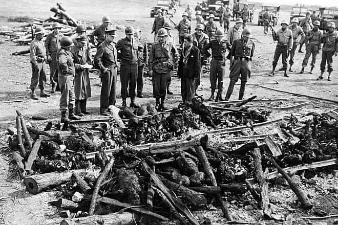 On an inspection tour of the newly liberated Ohrdruf concentration camp, U.S. Gen. Dwight Eisenhower and a party of high-ranking U.S. Army officers, including Gens. Omar Bradley, George S. Patton and Manton S. Eddy, view the charred remains of prisoners burned upon a section of railroad track during the evacuation of the camp, April 12, 1945. Credit: Courtesy of Harold Royall/United States Holocaust Memorial Museum via Wikimedia Commons.