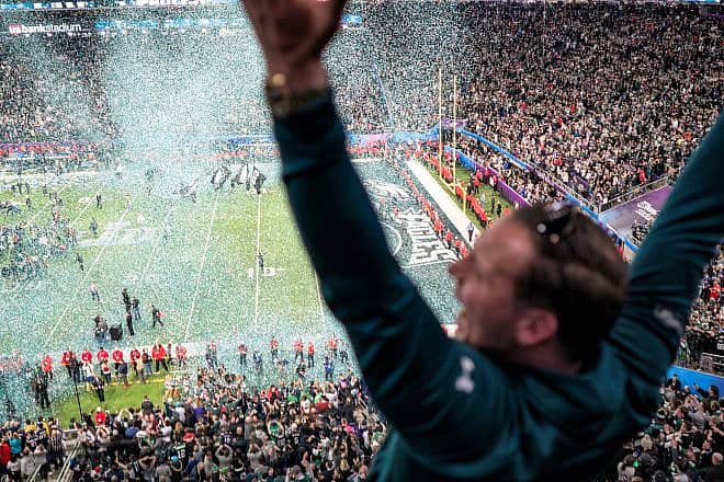 A Philadelphia  Eagles fan celebrates as confetti falls on the field in Minneapolis at Super Bowl 2018. Credit: Lorie Shaull via Wikimedia Commons.