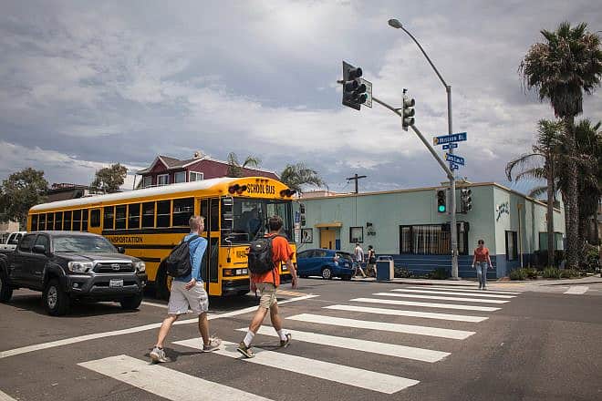 School-age teens crossing the street in the Mission Bay area of San Diego. Credit: Conchi Martinez/Shutterstock.